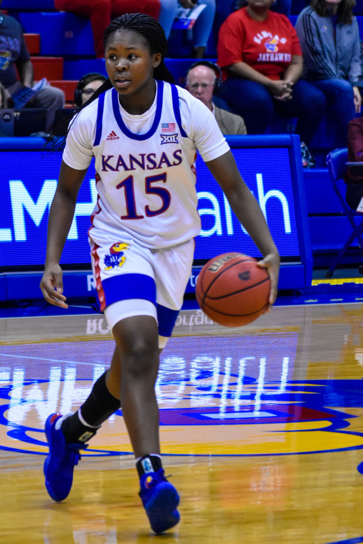 Zakiyah Franklin dribbles the ball and runs down the court in Allen Fieldhouse